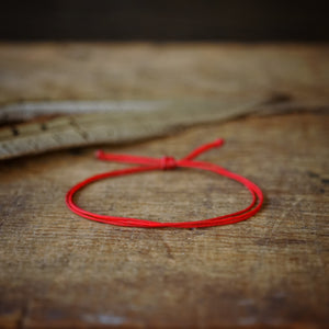 red string bracelet