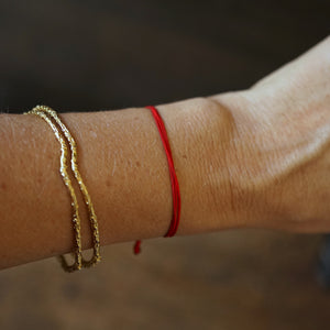 red string bracelet